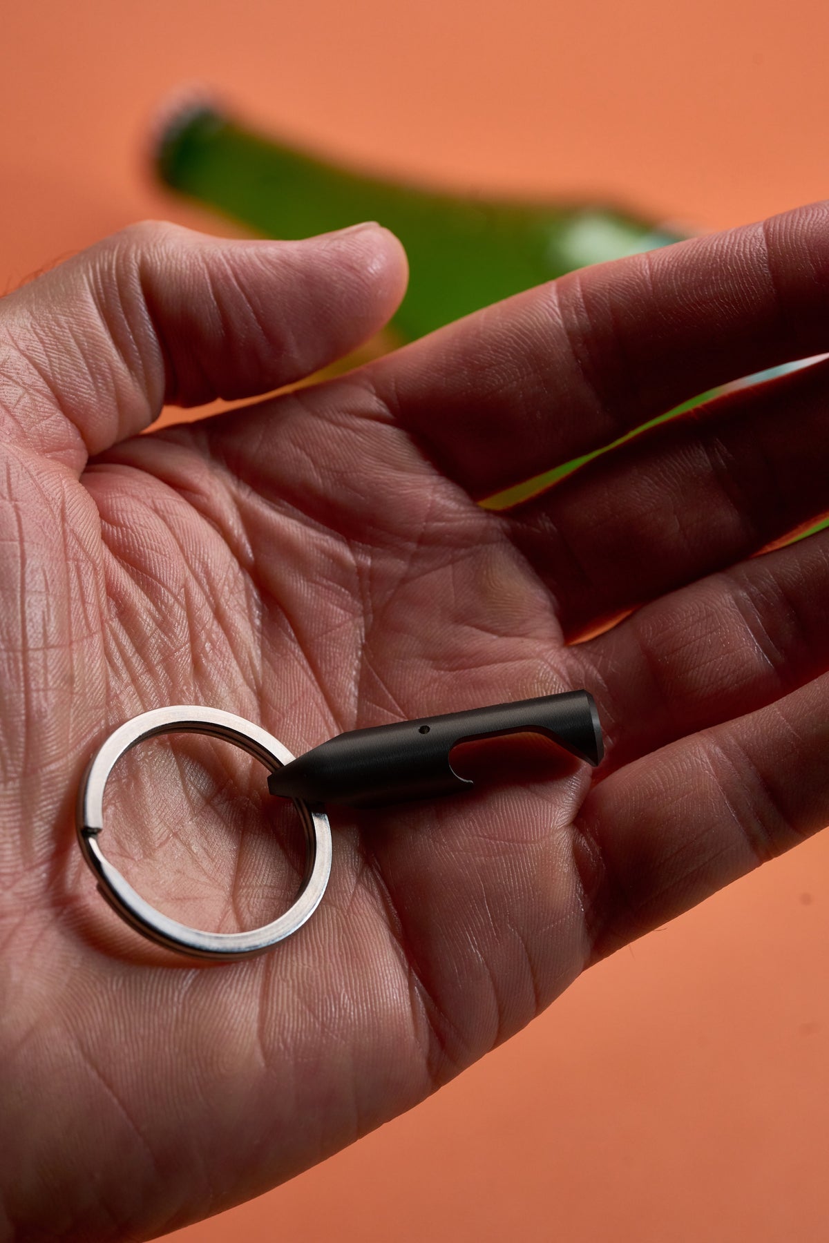 Bottle Opener - Black Steel held in an open palm