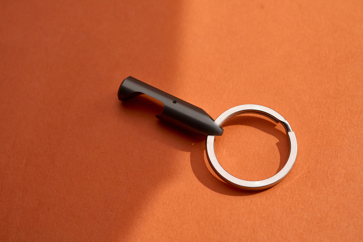 Bottle Opener - Black Steel on its key ring, angled