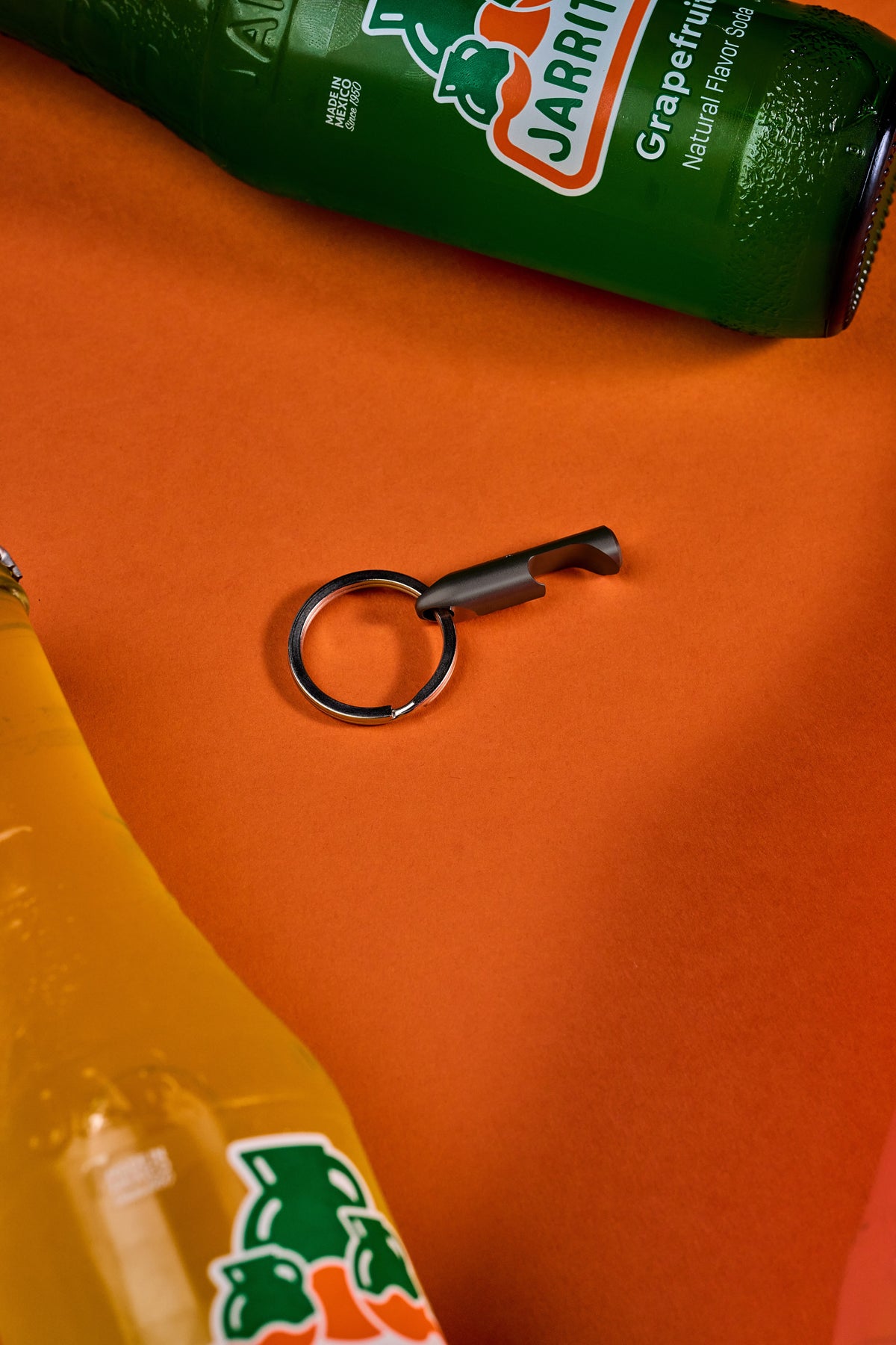 Bottle Opener - Black Steel on its key ring, close up