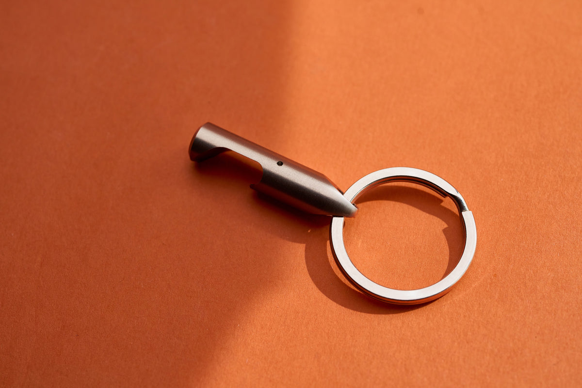 Bottle Opener - Titanium on its key ring, angled