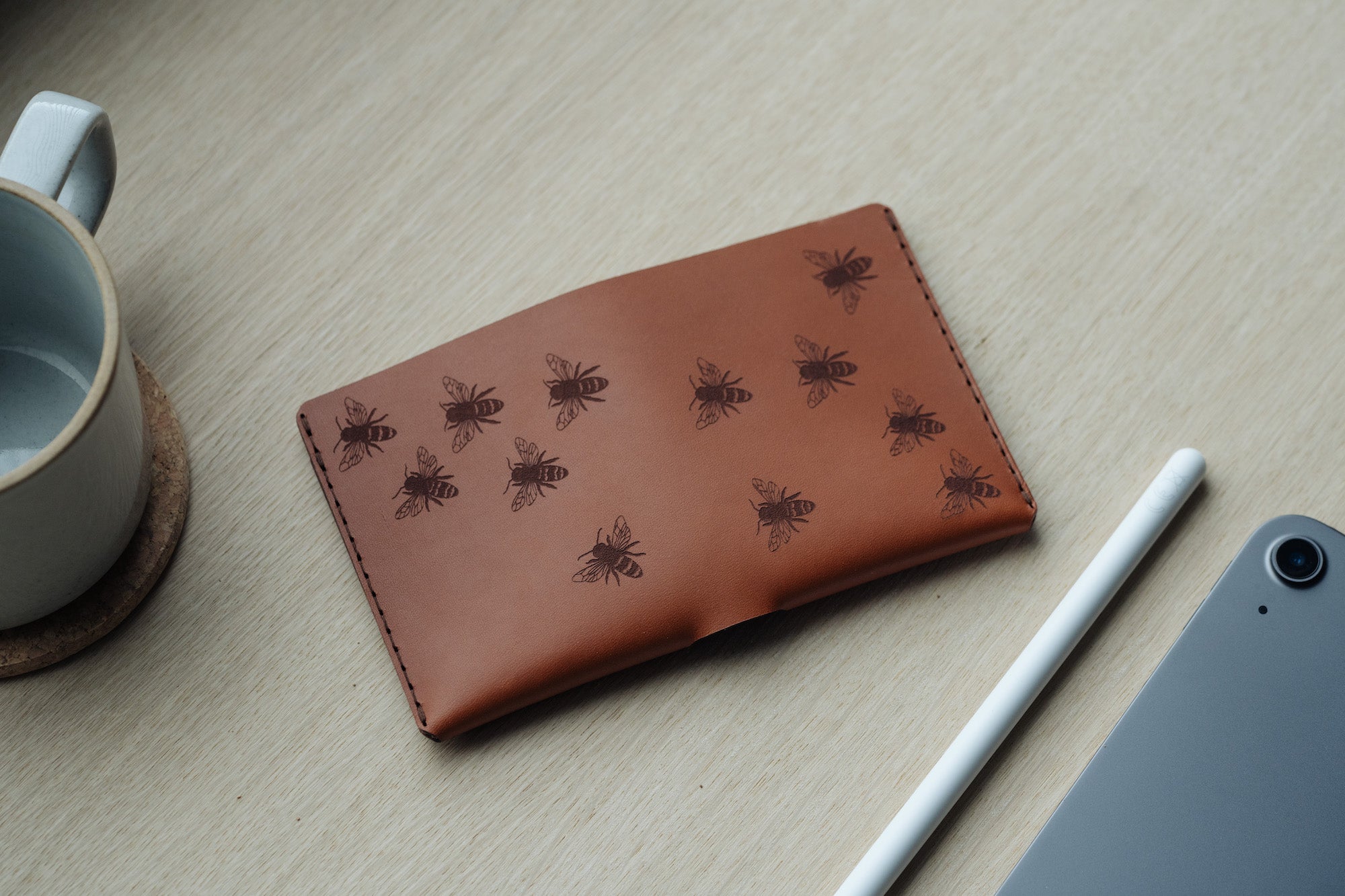 Brown leather wallet engraved with bee illustrations by Wingback in collaboration with artist Jan Perit 