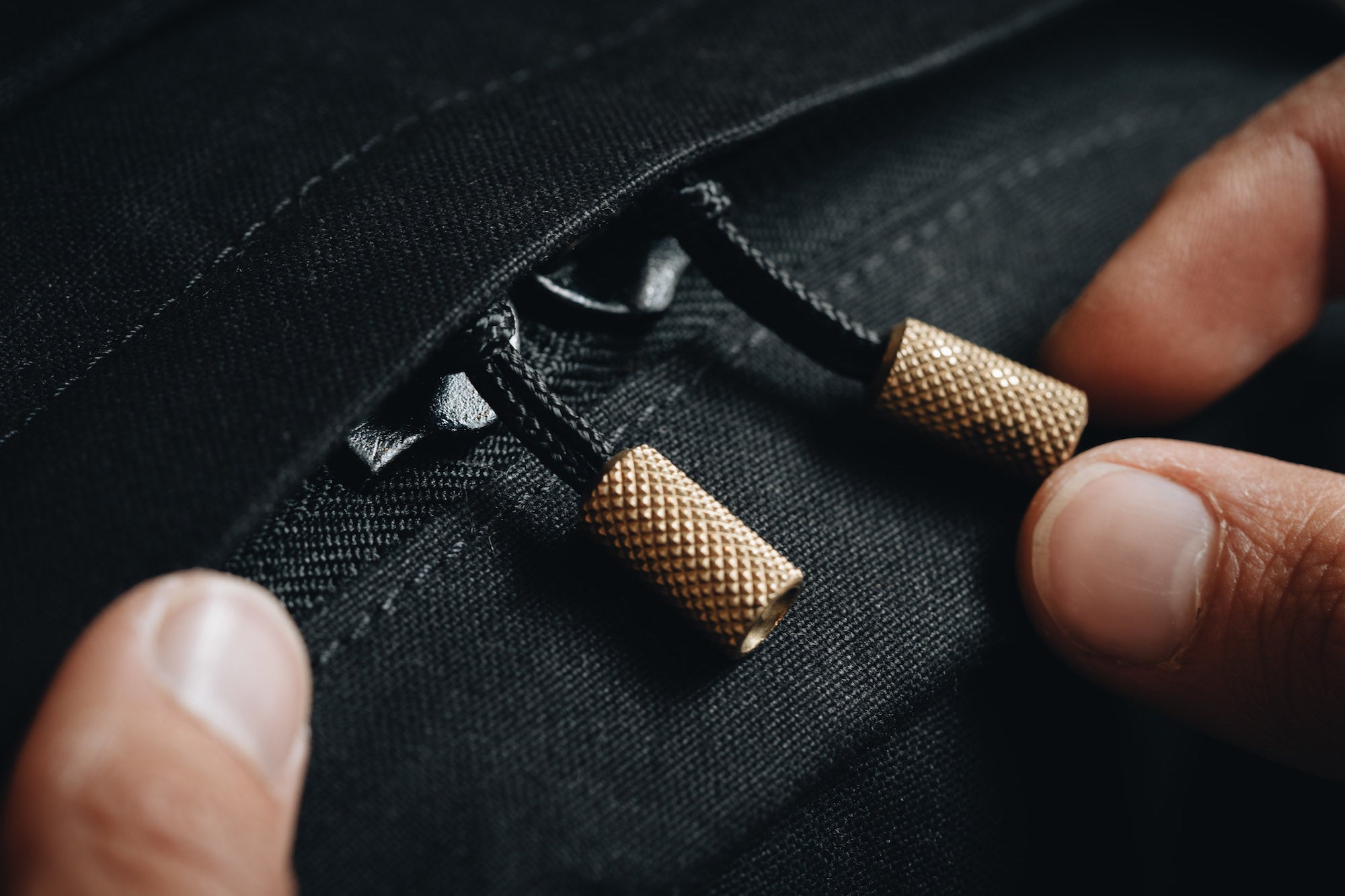 Brass knurled pullers with a black UHMW cord on the Wingback Day Pack