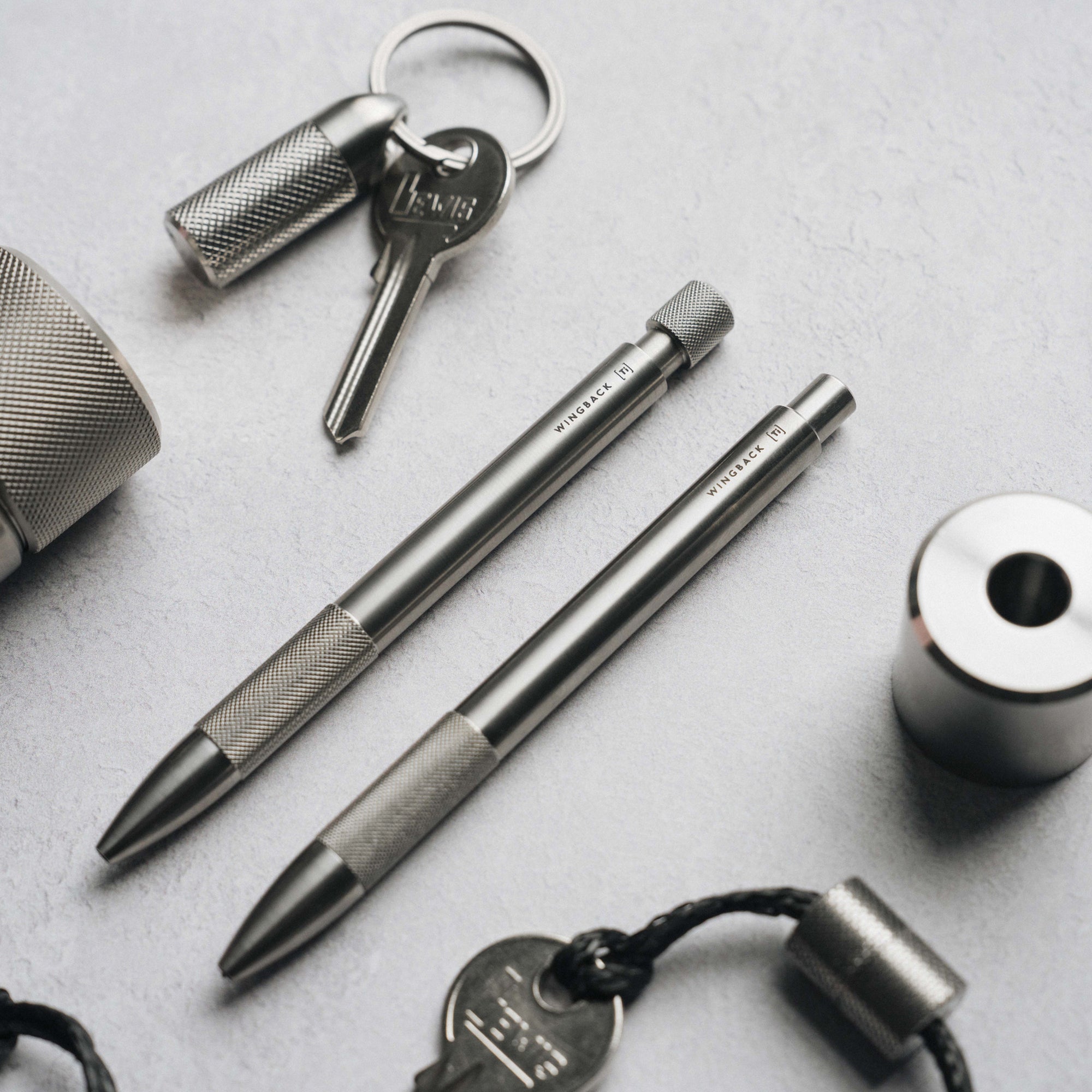 Titanium EDC gear by Wingback including a mechanical pen and pencil