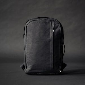 Waxed cotton backpack by Wingback in black with machined pullers 